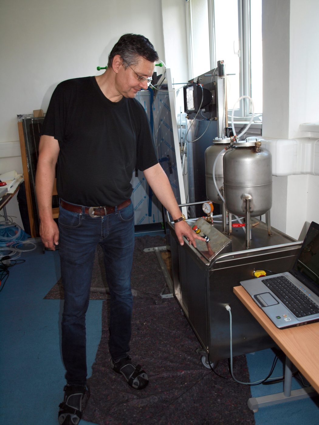 Vladislav Poulek, founder of Inova Solar, at the silicone-gel lamination machine in the company's laboratory.